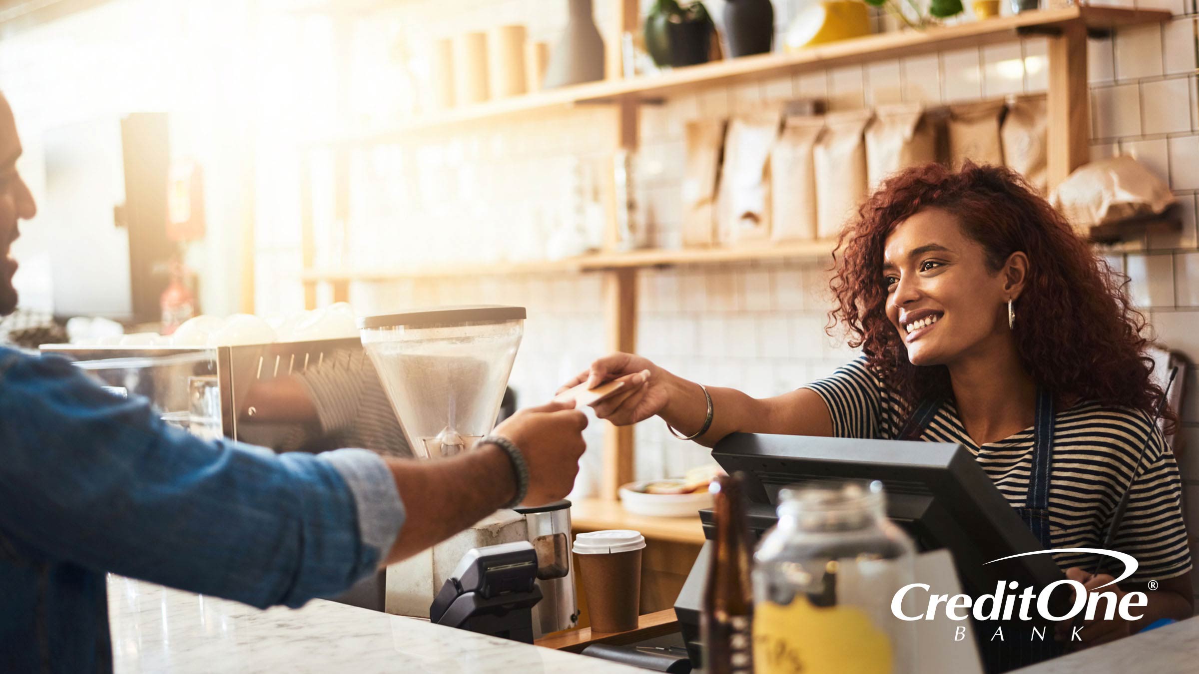 Man using a credit card to make a purchase at a coffee shop